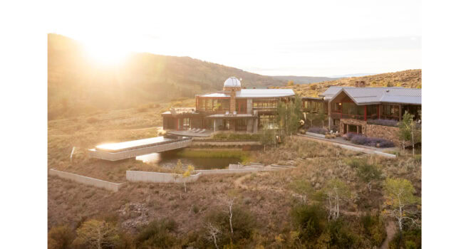 From above, the home appears to emerge from the land. Replaced lawns give way to native cover, bark chip trails weave through meadows, and the entire property reads as a model of dryland resilience and restoration.